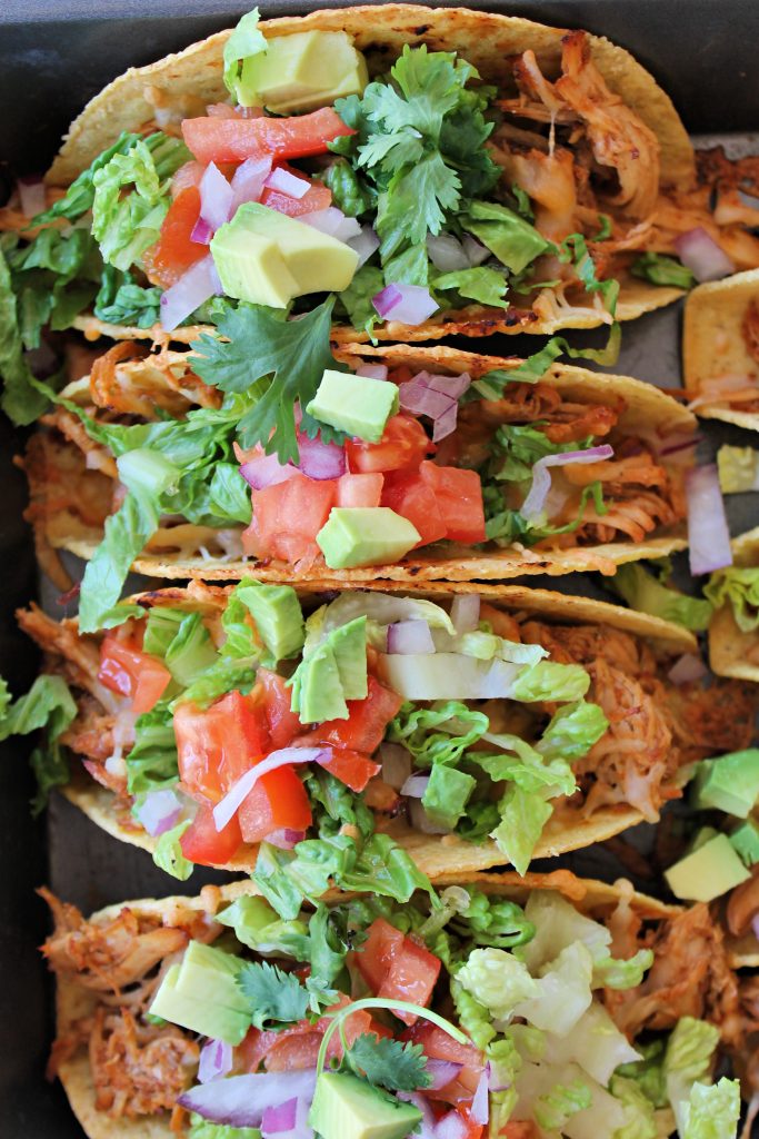 Oven Baked Chicken Tacos with tomatoes and garnish